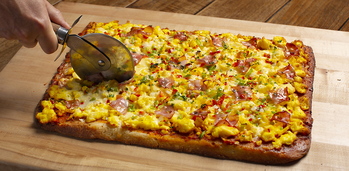 Pizza being cut on a table